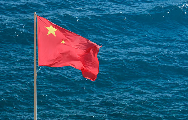 Chinese National Flag At The Coast Near The Sea On A Sunny Day