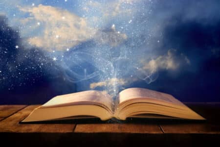 Image Of Open Antique Book On Wooden Table With Glitter Overlay